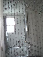 the doorway to my bathroom as seen through the beaded curtains